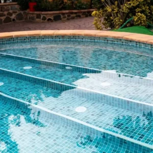 Mosaic tile manufacturer´s catalogue picture showing a swimming pool covered with green mosaic tiles