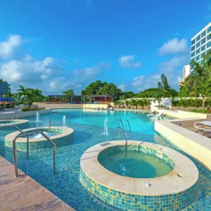 image of swimming pool decorated with green and blue tiles 